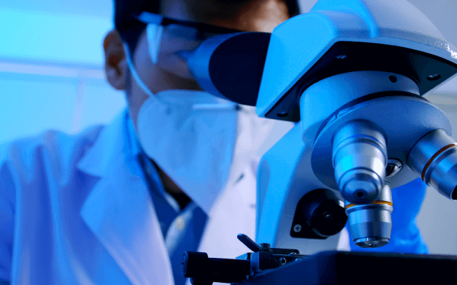 Photo of scientist using a microphone